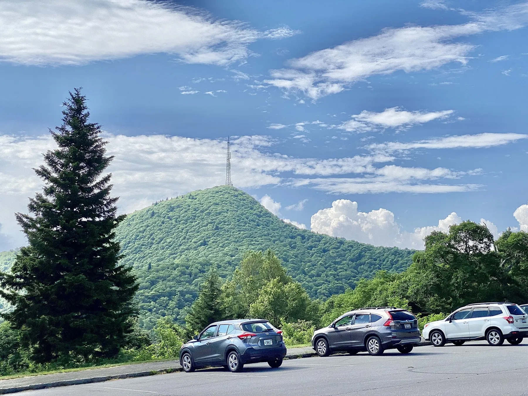 Mount Pisgah's forested peak rising behind a Parkway parking area