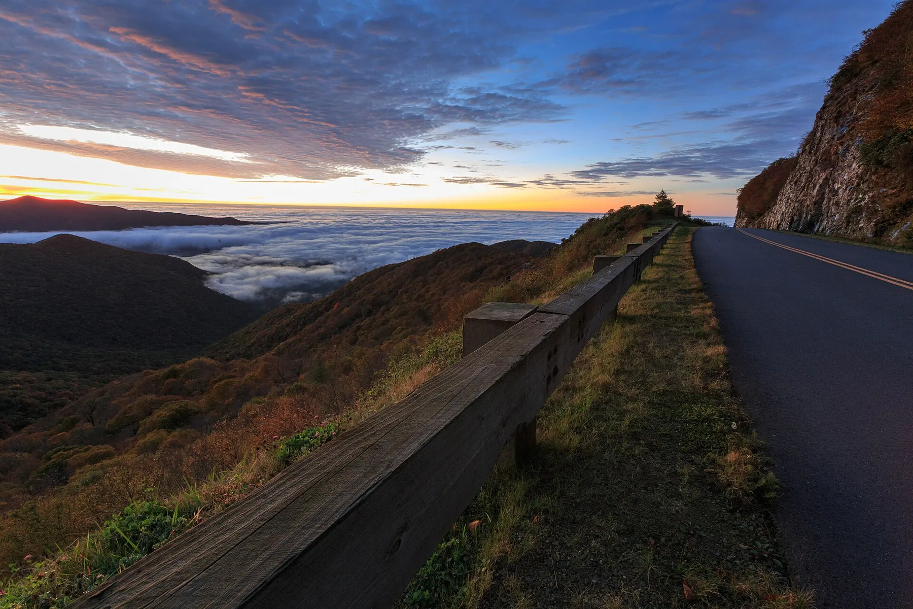 The road to Craggy Gardens on the Blue Ridge Parkway at sunrise, with clouds in the valleys below