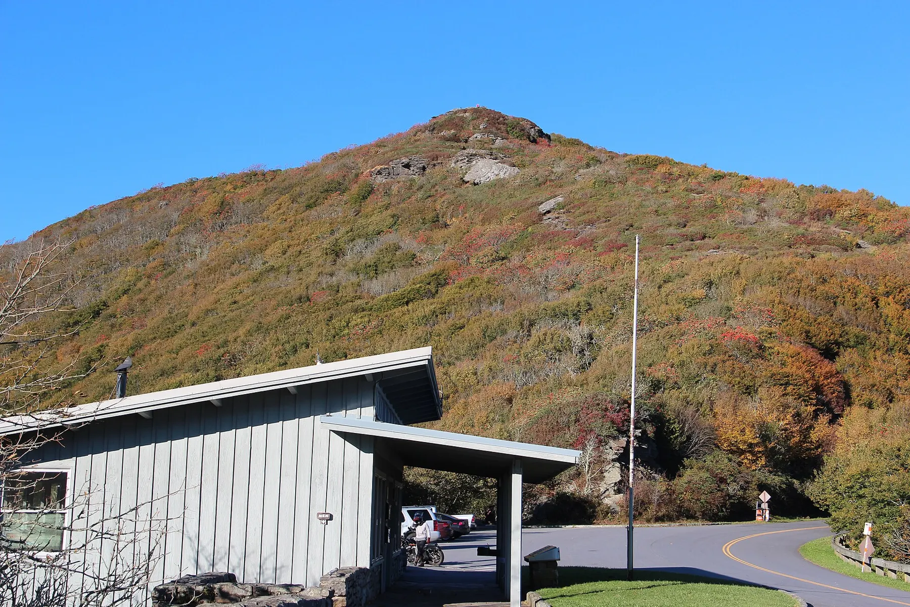 Craggy Pinnacle's slope in fall colors behind the Craggy Gardens Visitor Center