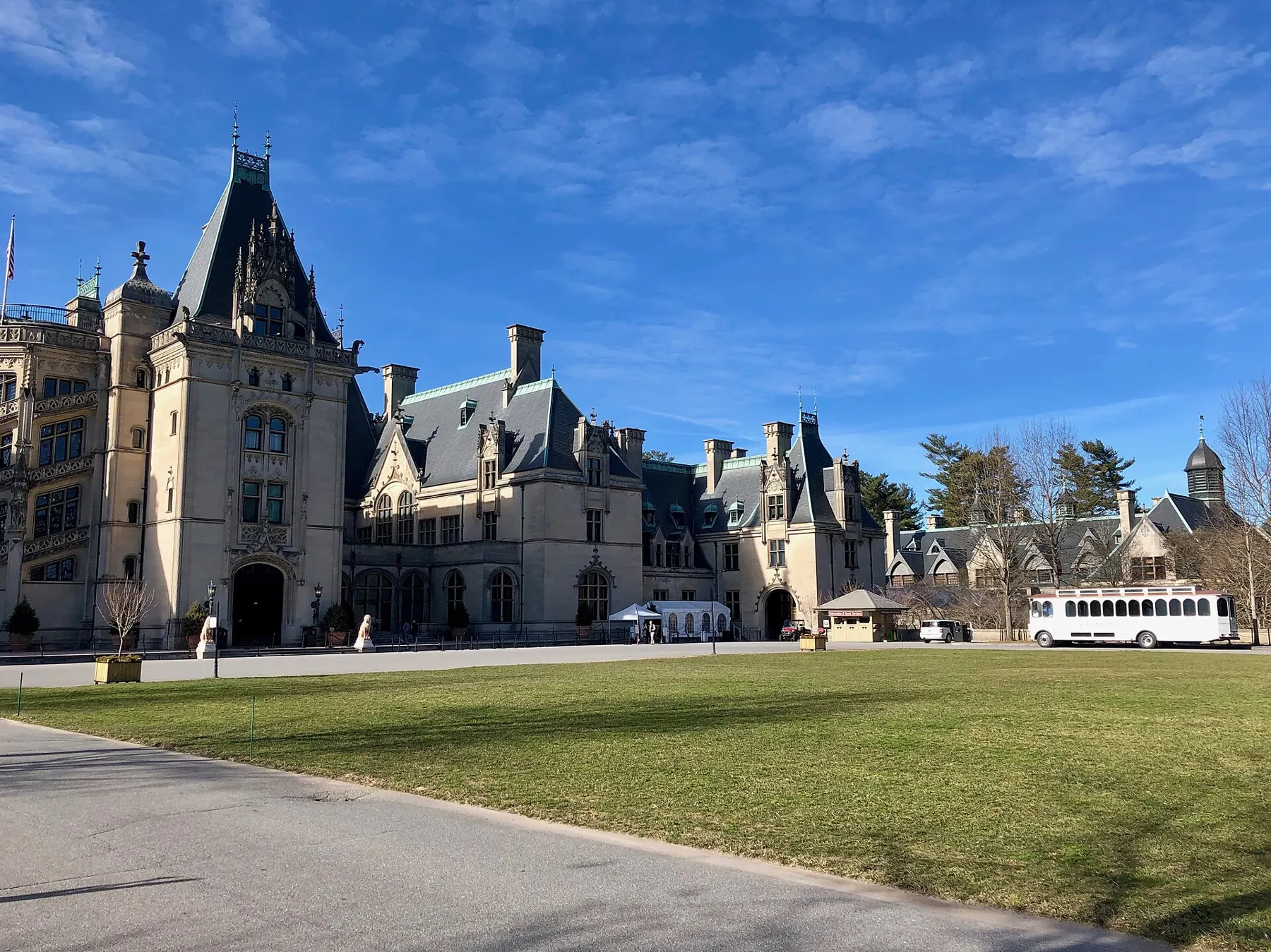 The front of Biltmore House across its lawn on a clear day